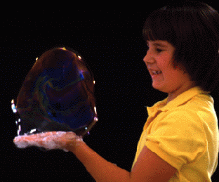 Girl holding bubble.