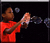 Kid blowing bubbles with hands.