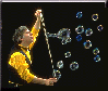Professor Bubbles blows bubbles using a piece of string.