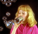 Girl blowing bubbles with a tin can